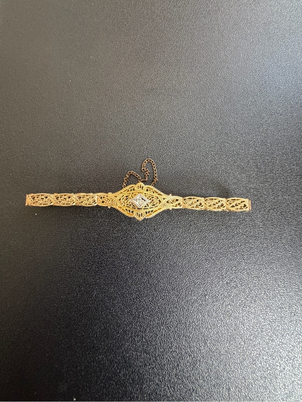 1920’s Vintage Elegant gold filigree bracelet w/ a clear, diamond center accent.